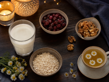 Tart cherries walnuts warm milk and oats on a table as foods that help you sleep