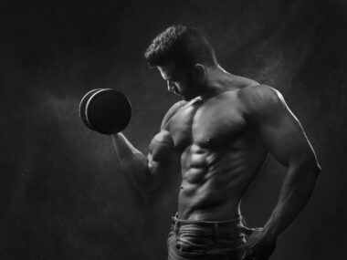 Fit man over 40 lifting weights in gym