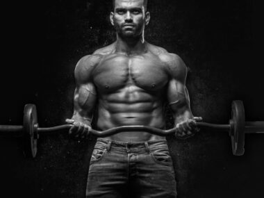 Man doing barbell squat in gym to build muscle