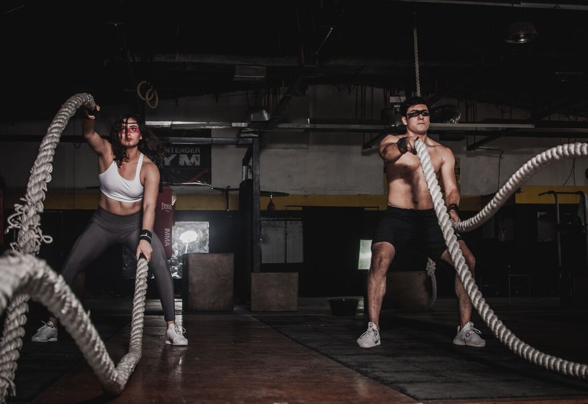 Woman exercising in gym with dumbbells