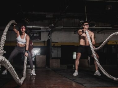 Woman exercising in gym with dumbbells