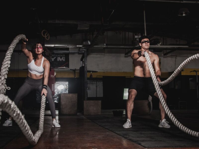 Woman exercising in gym with dumbbells
