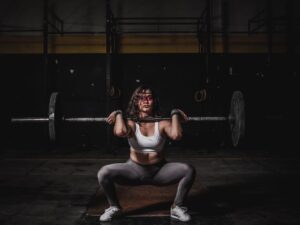 Woman on treadmill cardio versus strength training weights