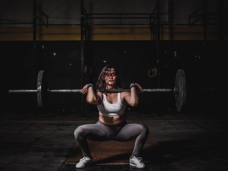 Woman on treadmill cardio versus strength training weights