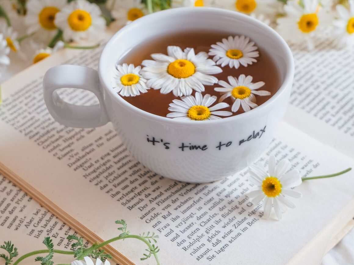 Chamomile tea and a book on a cozy bed, a calming bedtime ritual for better sleep