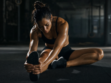 Workout recovery tips - athlete stretching after exercise