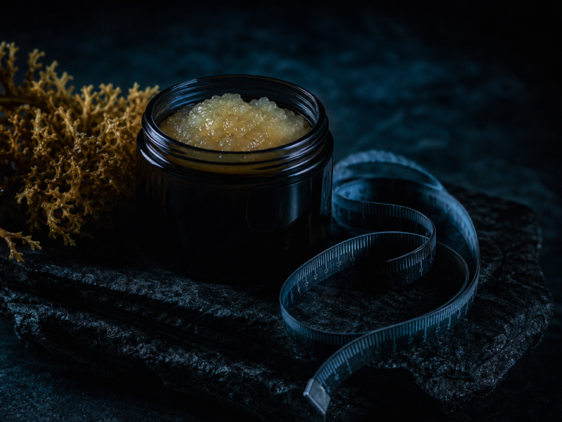 Sea moss gel in dark glass jar with dried seaweed weight loss concept