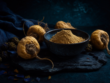 Maca root benefits - maca powder and root on dark background