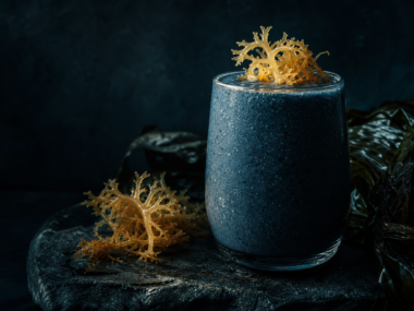 Sea moss gel smoothie with fresh sea moss on dark background