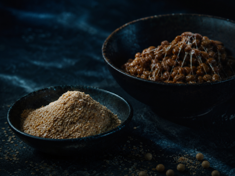 Wheat germ and natto fermented soybeans in dark ceramic bowls