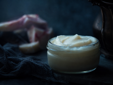 Beef tallow for skin - jar of tallow moisturiser on dark background