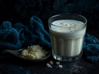 Kefir benefits - glass of kefir with fermented milk grains