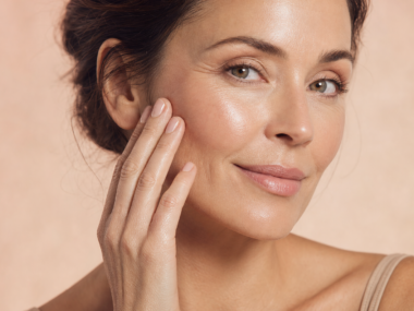 Mature woman touching her smooth glowing skin after cleansing — skincare tips for tight skin